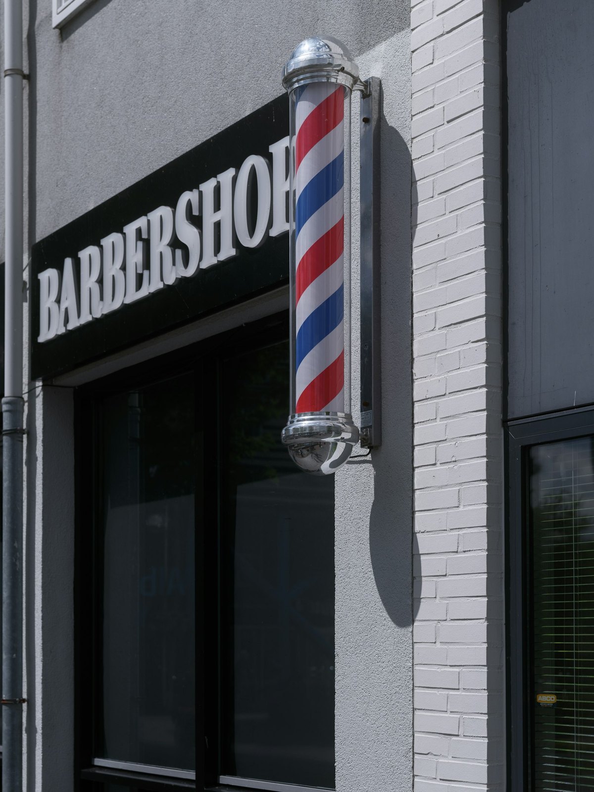 The HairLab. shopfront on Sean Costello Street, Athlone — black BARBERSHOP sign and a red, white and blue barber pole on the wall